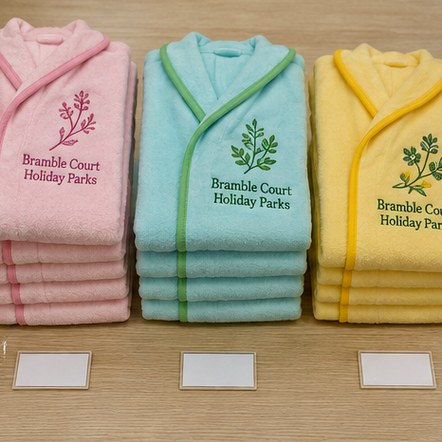 Customized bathrobes for family resorts and swim schools